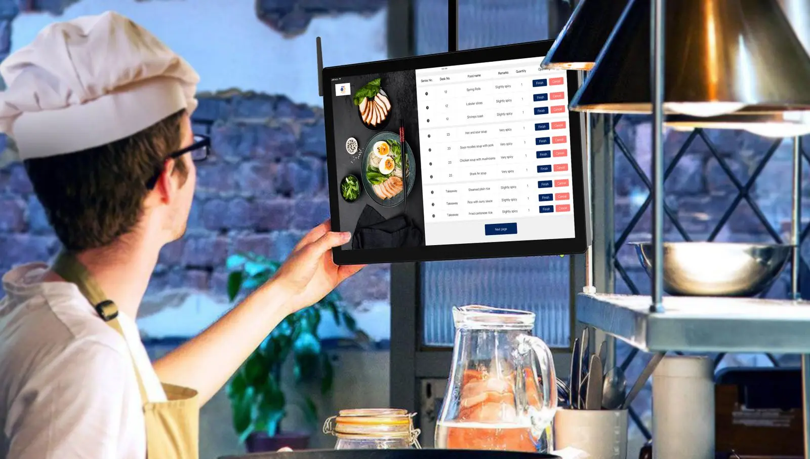 Cook in a white hat checking a wall-mounted kitchen screen that lists incoming dine-in and takeaway orders